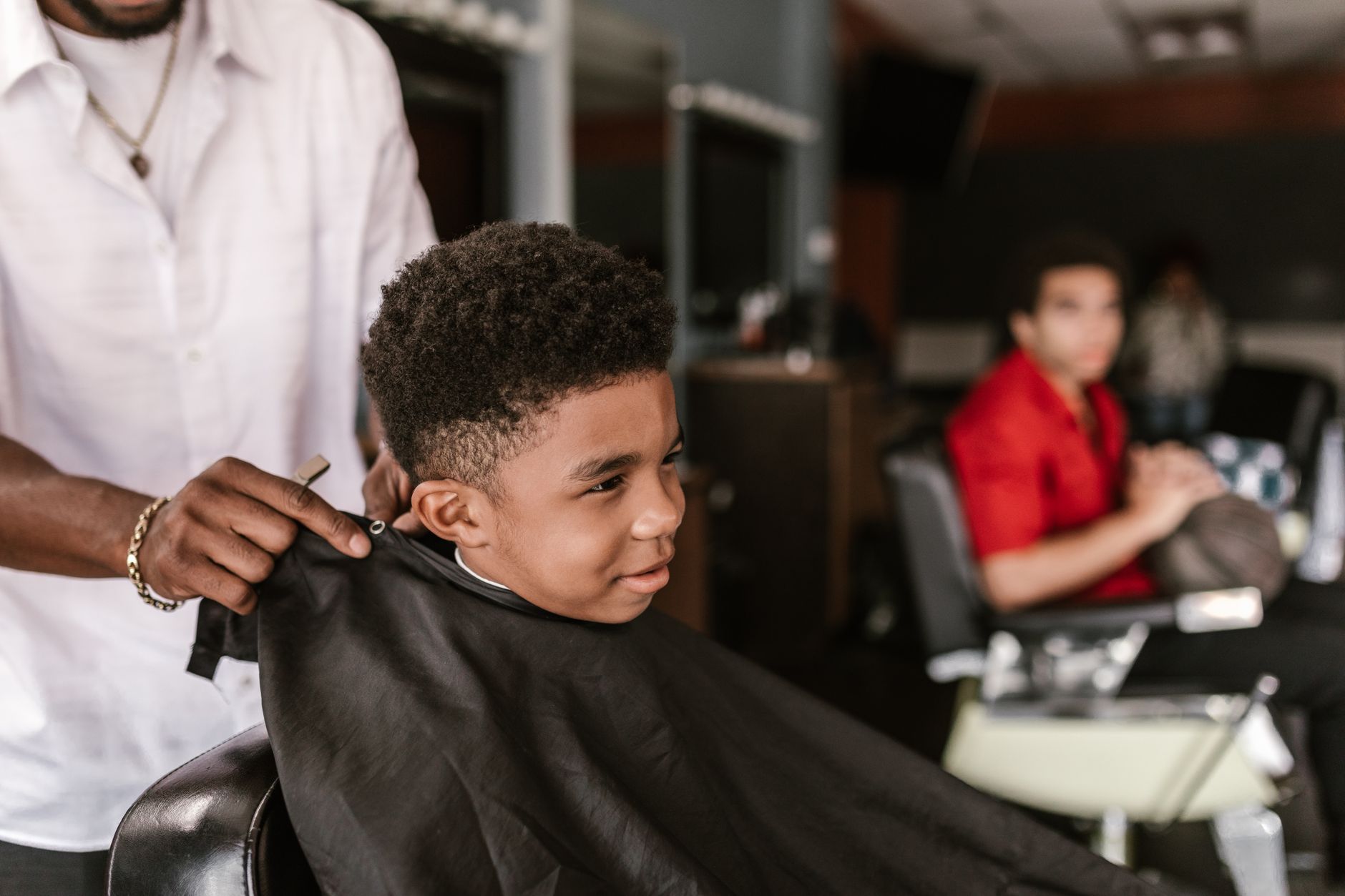 A young boy getting a patient, easygoing haircut